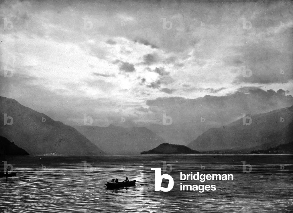 Panoramic view of Lake Como with a small rowboat in the foreground