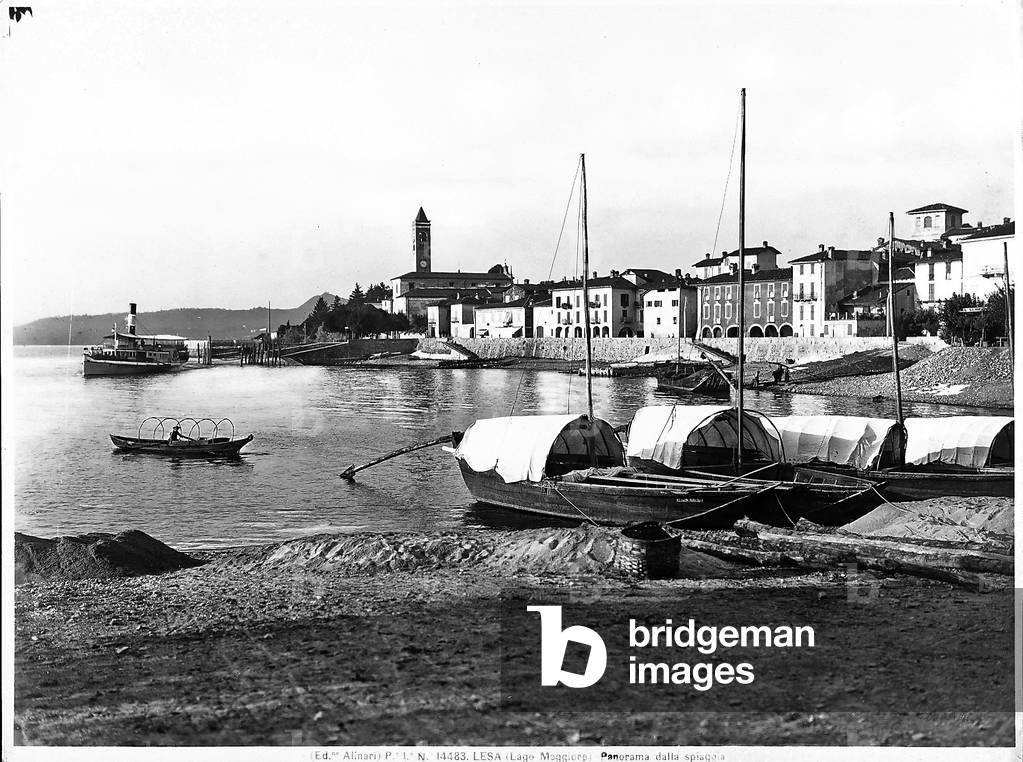 View of Lesa on Lake Maggiore with boats mooring in the foreground