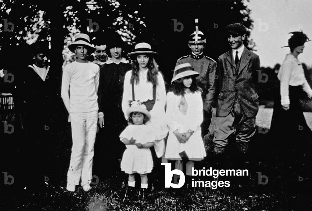 The Princes Umberto, Mafalda, Giovanna and Maria of Savoy shown in the company of a group of friends in the park of Villa Savoia in Rome