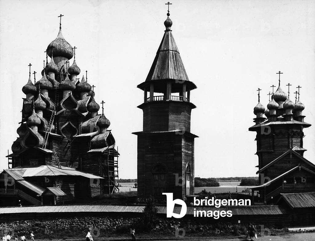 The bell tower and dome of a picturesque wood church in the Russian countryside