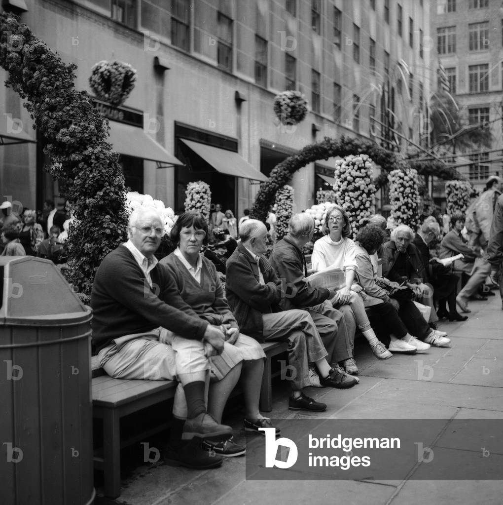 Scene of the conversation on the benches of the Rockefeller Center in Manhattan, New York City (b/w photo)