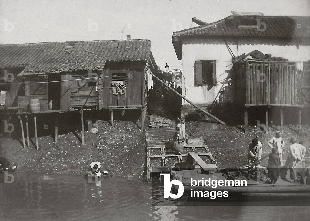 Stilt houses located along the banks of a river, in a Japanese village, 1890 (print on double-weight paper)