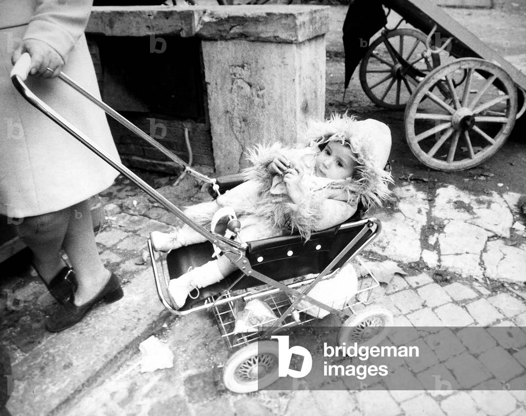 Baby dressed in winter clothes in a stroller