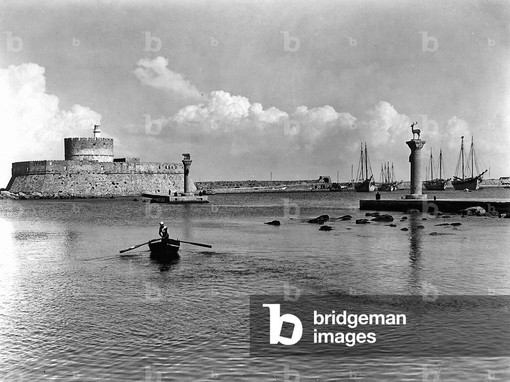 Entrance to the port of Rhodes with the Fort of St. Nicholas and two bronze columns of the deer and the Capitoline she-wolf.