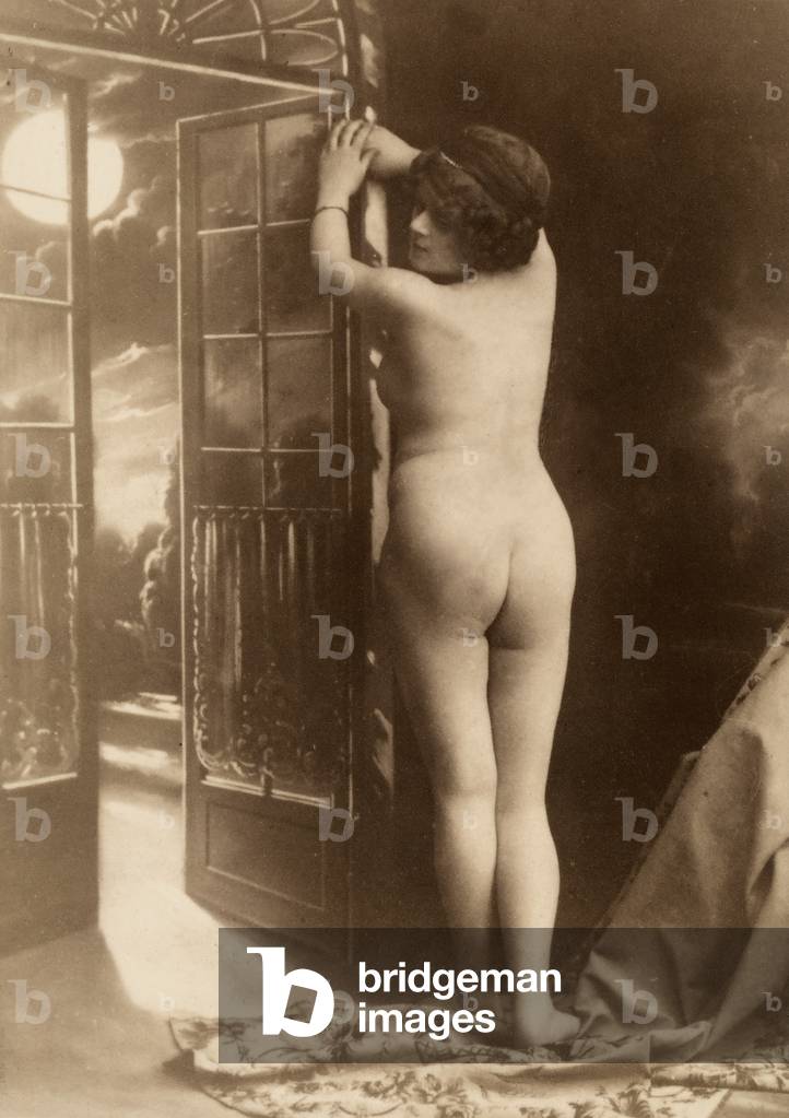 Nude portrait of a young woman seen from the rear.