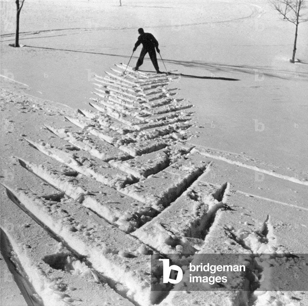 Ski tracks in the snow. In the background the skier