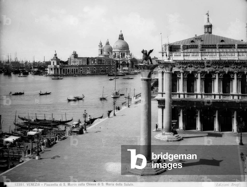 View of the lagoon from Piazzetta, S. Marco, Venice. Two monolithic columns topped by a statue of the Lion of St. Mark and St. Theodor and the Church of S. Maria della Salute.