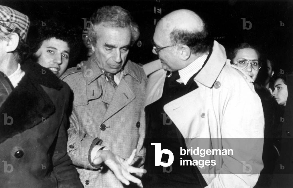 Film director Francesco Rosi hugging Michelangelo Antonioni
