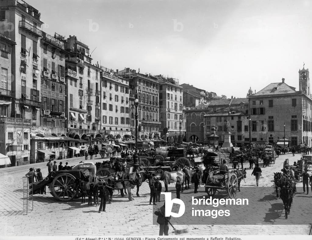 Busy view of piazza Caricamento in Genoa, in the background is the sailor Raffaele Rubattino sculpted by Augusto Rivolta.