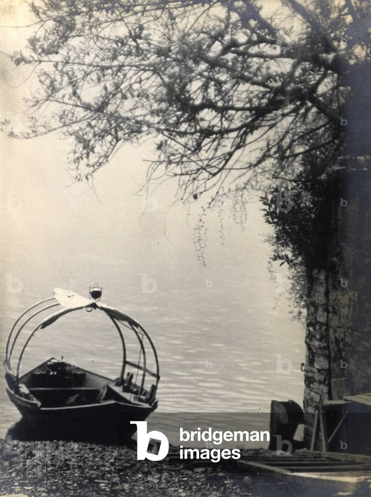 A typical Lake Como boat pulled up on the shore of the lake