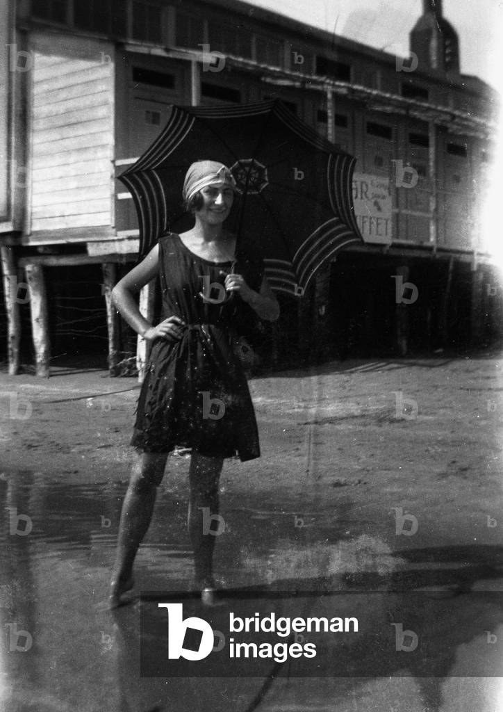 Woman in a bathing suit posing with an umbrella