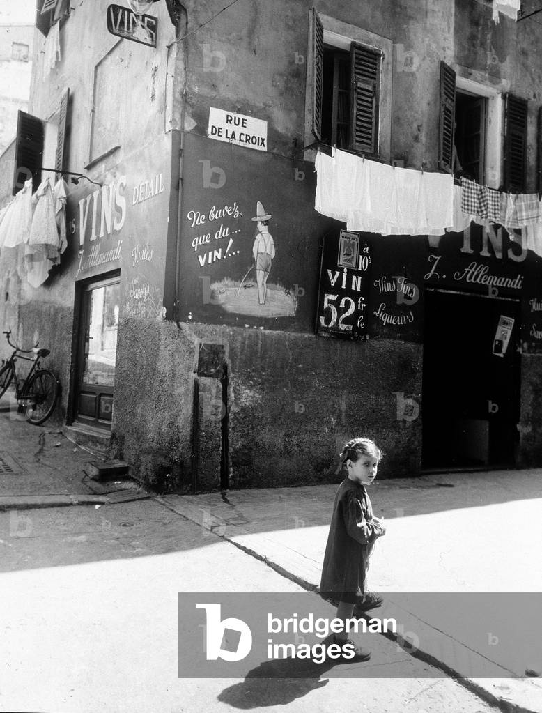 A little girl on a characteristic streetcorner, Rue de la Croix, Nice, France, c.1950 (b/w photo)