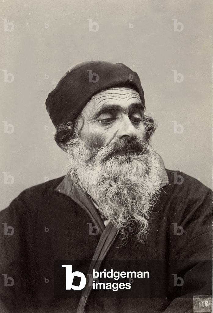 The image shows an old Tunisian bearded man; he wears a cap and a dark dress,  1870 (print on double-weight paper)