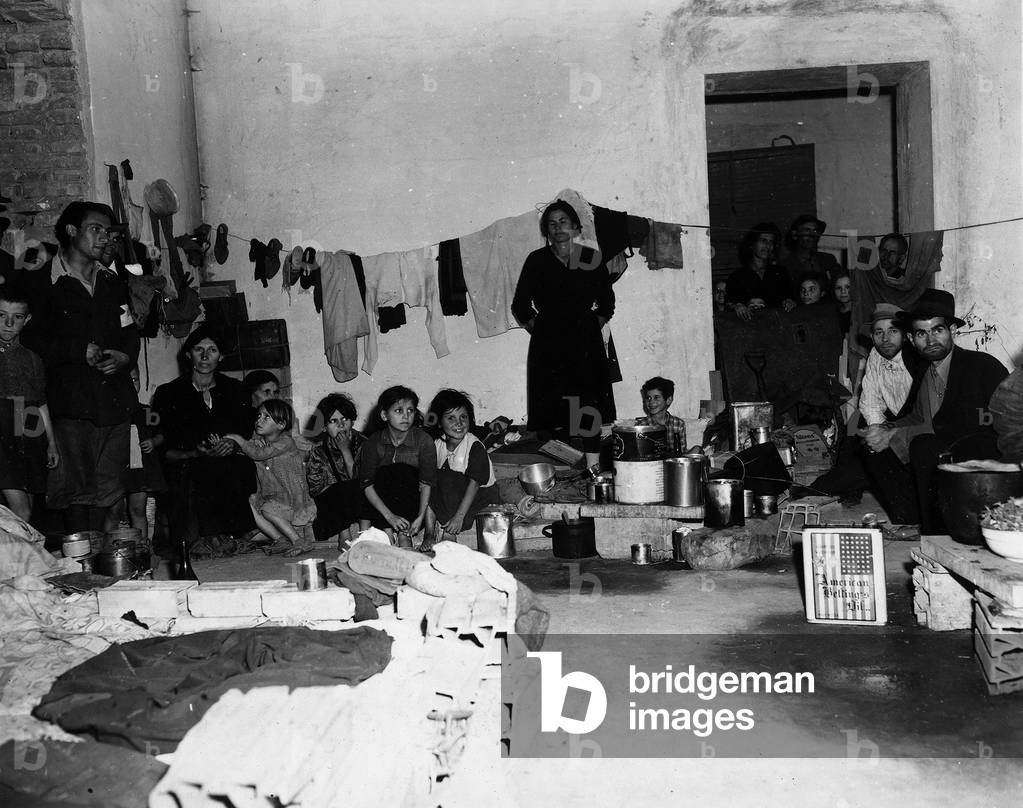 Family from Cassino living in a crowded room of the camp of Cesano (b/w photo)