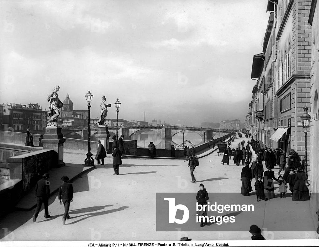 View with people of Lungarno Corsini and a small part of the Santa Trinita Bridge.