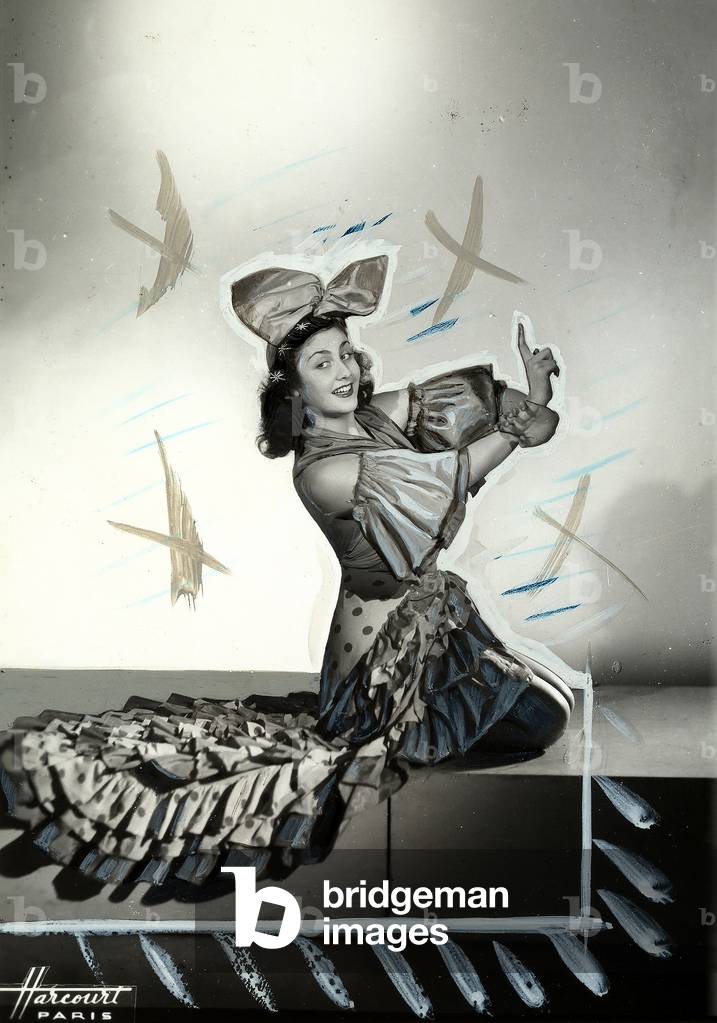 Portrait of the ballerina Nina Kara, in costume performing a dance step.