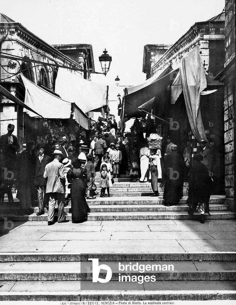 View of the Rialto Bridge with people, in Venice