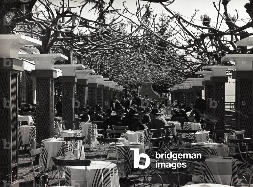 Group of people sitting at the café during a fashion event