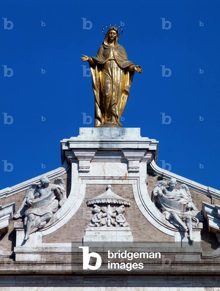 The statue of the Virgin, gilded bronze by Guglielmo Colasanti, on the pediment of the façade of the Basilica of Santa Maria degli Angeli of Assisi (photo)