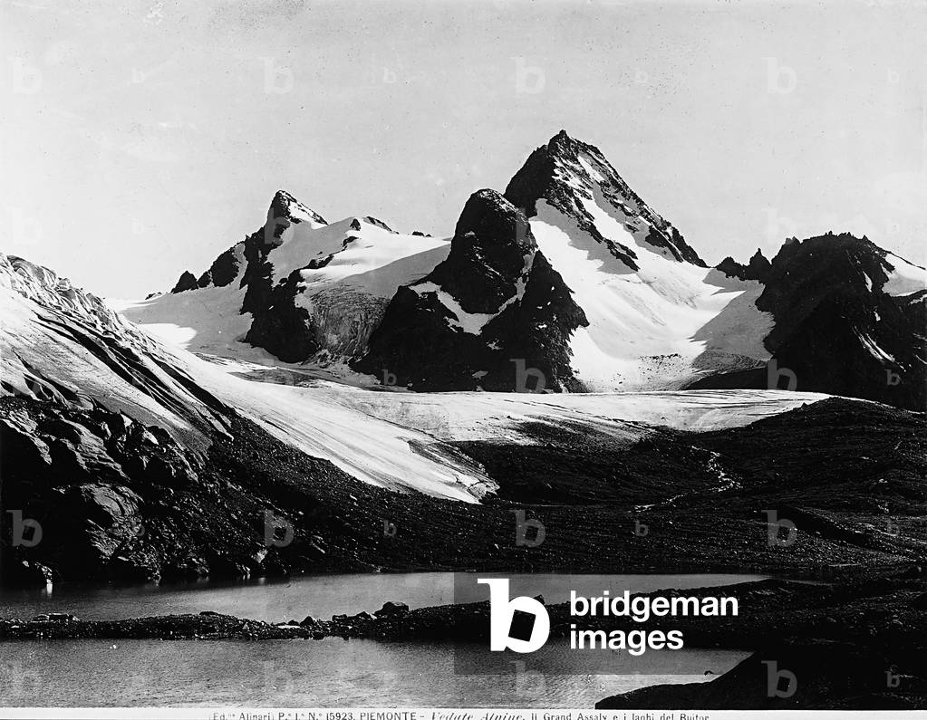 View of lakes and alpine peaks with snow in Piemonte