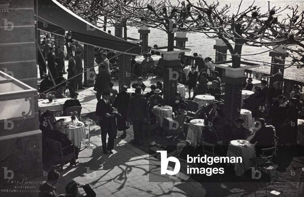 Group of people sitting at the café during a fashion event