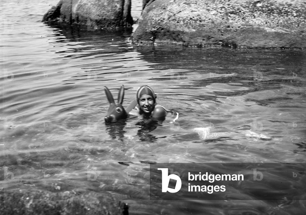Woman while bathing in a cove of the island