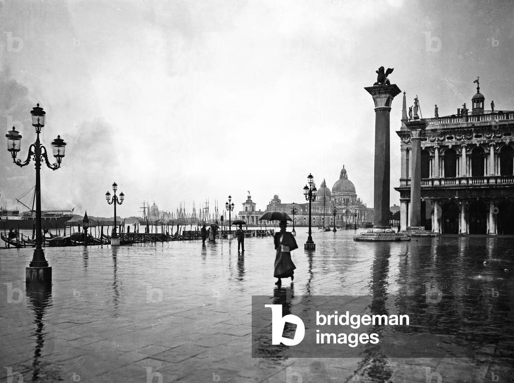 View of the lagoon from Piazzetta San Marco in the rain. The monolithic column topped by a statue of the Lion of St. Mark and the Church of Santa Maria della Salute are clearly visible