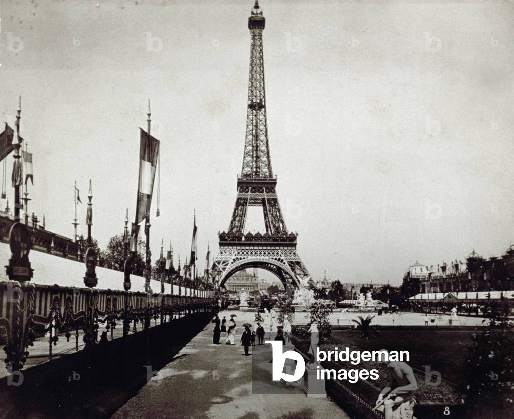 The Eiffel Tower and the Gardens of Champs De Mars in Paris, prepared with pavilions for the World's Fair of 1889. In the background, the Trocadero