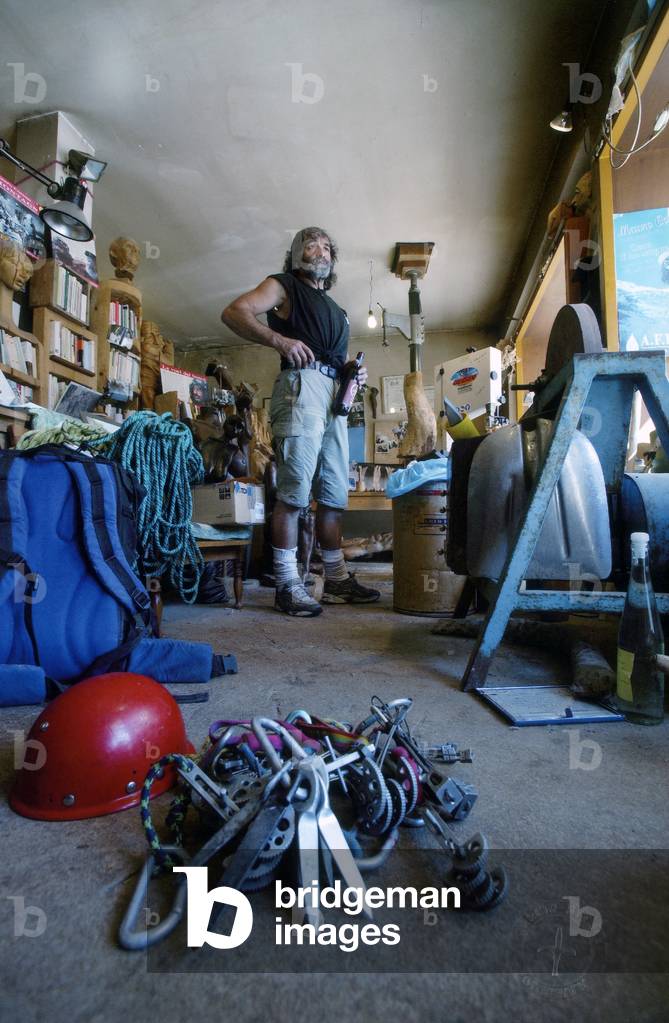Portrait of the sculptor and writer Mauro Corona in his studio, Erto (b/w photo)