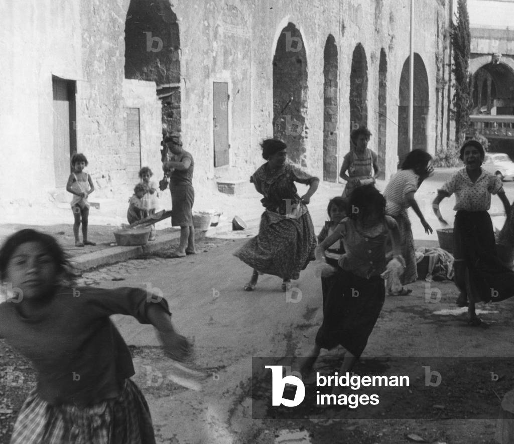 Gypsy on the run in degraded Mandrione in Rome (b/w photo)