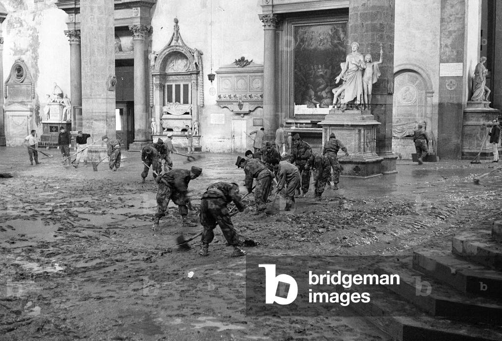 Soldiers clean mud from the interior of the Church of Santa Croce after the flood of Florence, November 1966 (b/w photo)