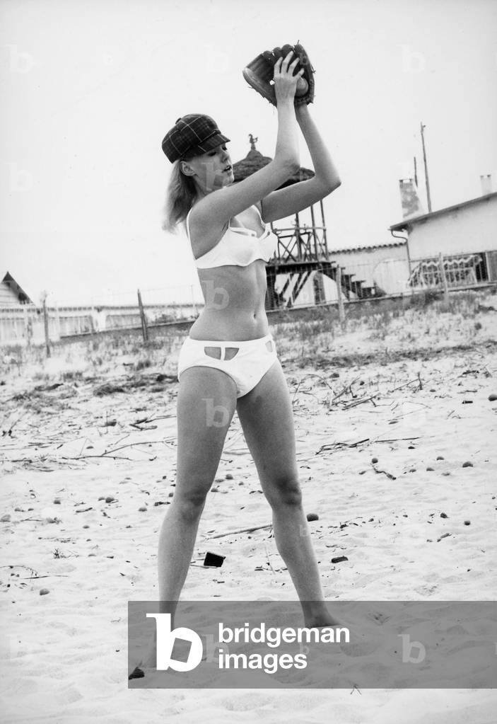 Portrait of Alicia Brandet while playing baseball at the beach.