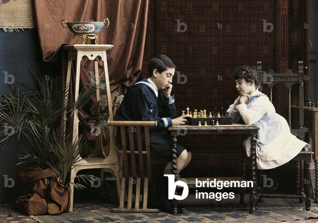Two children playing chess