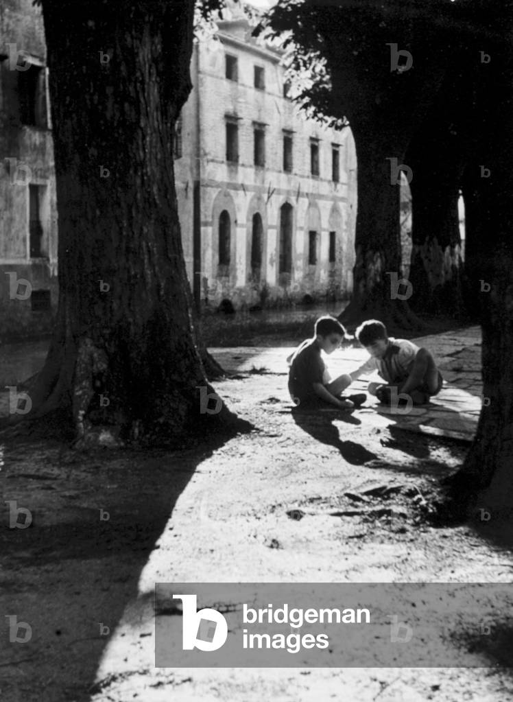 Two boys playing in the street