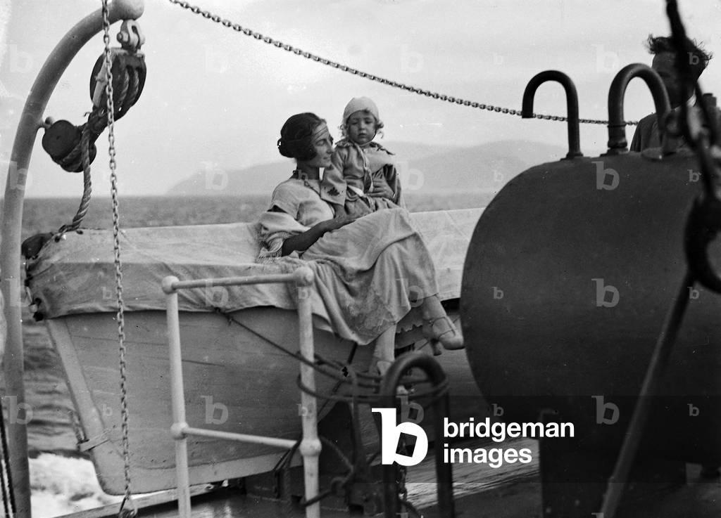 Female portrait with baby on board a ship