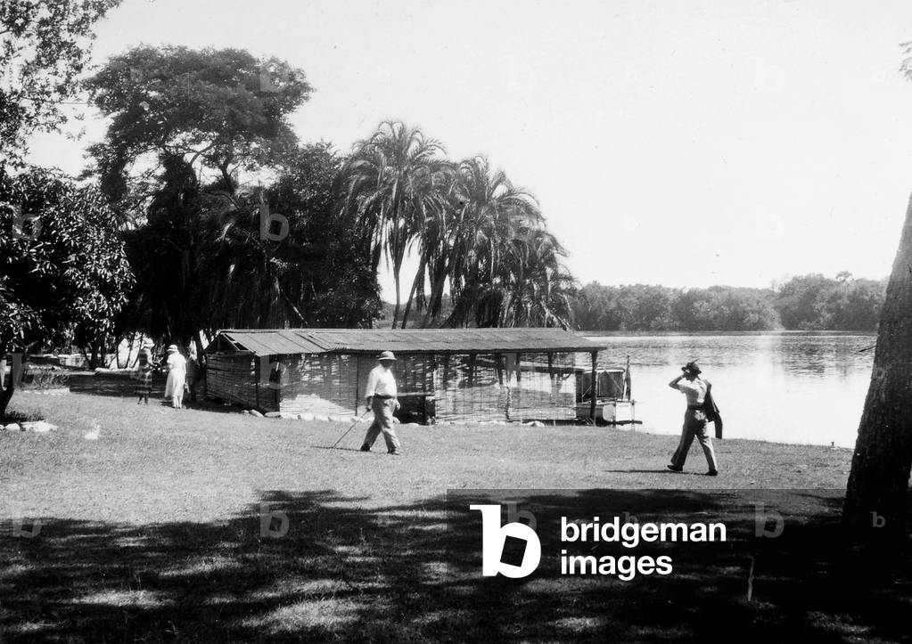 People walking along the banks of the river Zambesi near Victoria Falls
