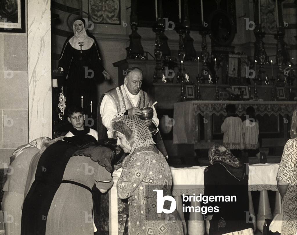 Old ladies taking Holy Communion during church services.