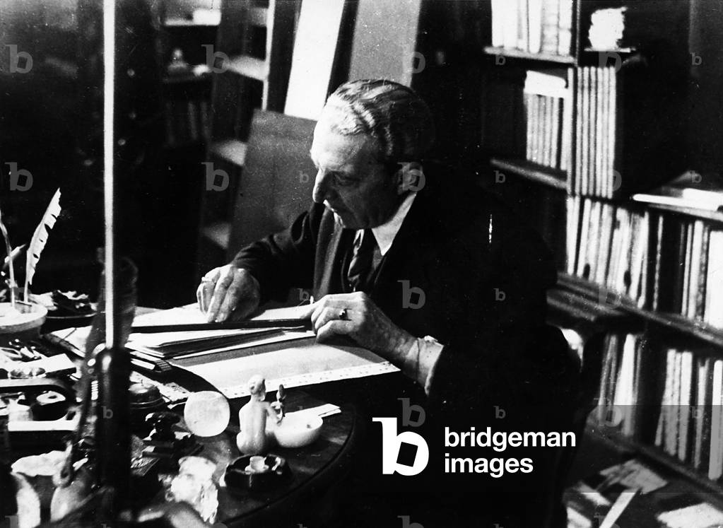 The poet Trilussa photographed in his study