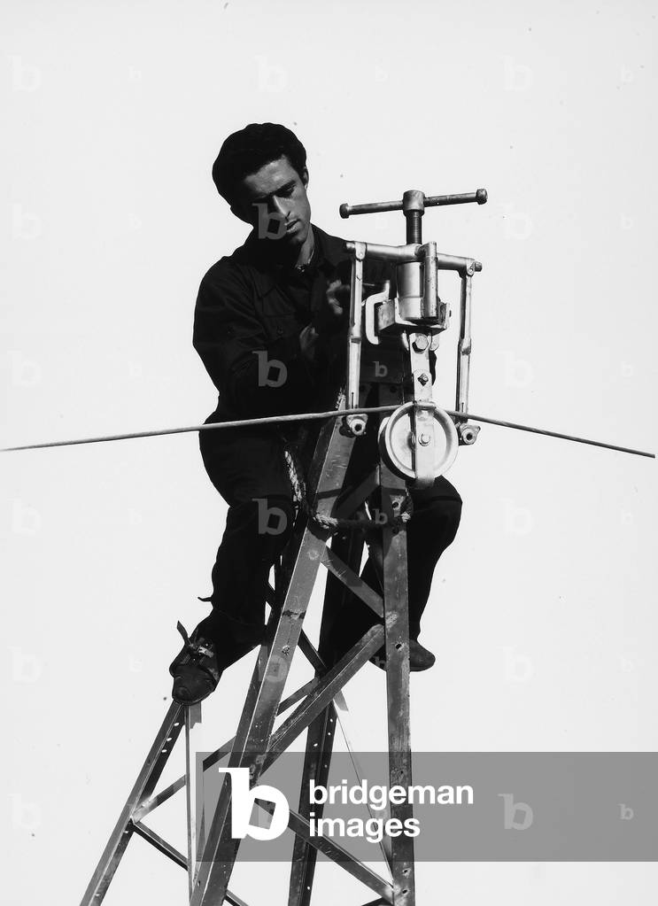 Bologna Electrical Society: worker on top of a grating.