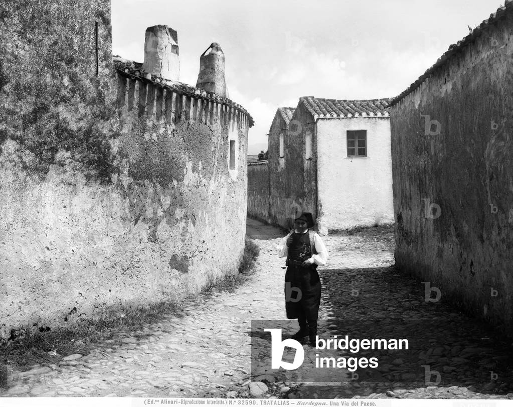 View with people of a street in the town of Tratalias, Sardegna.