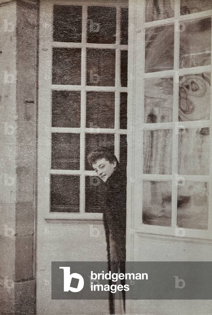 Madame Ricardo looking out a pair of French doors