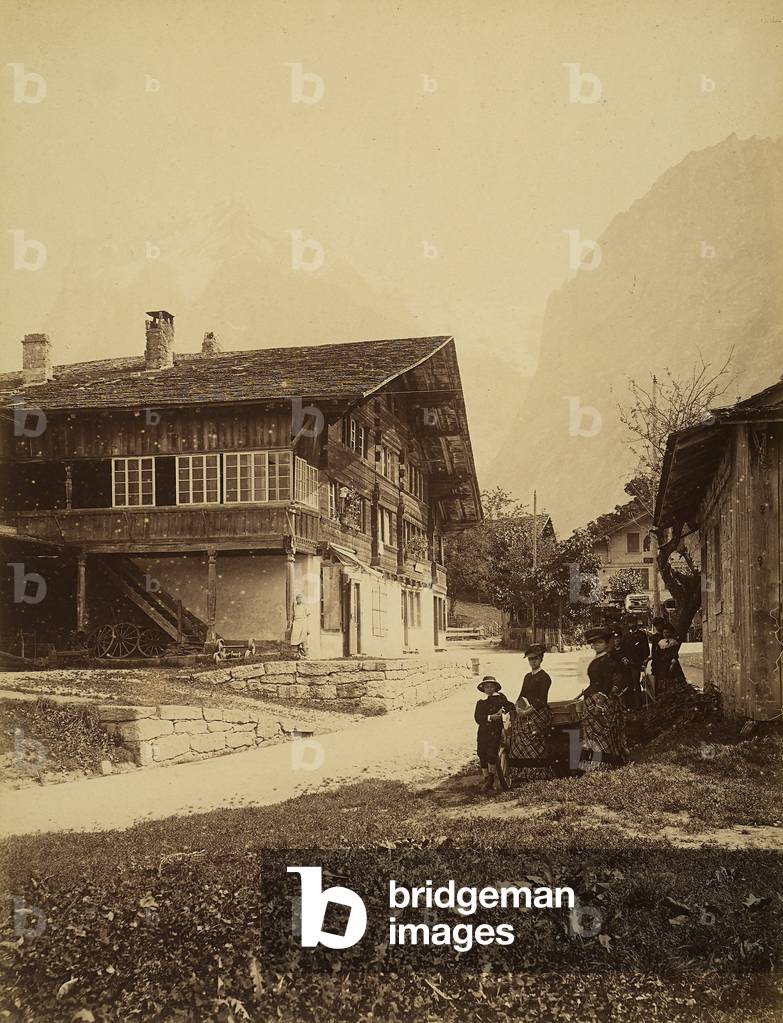 A group of people stopping along a road in the valley of Grindelwald, Switzerland