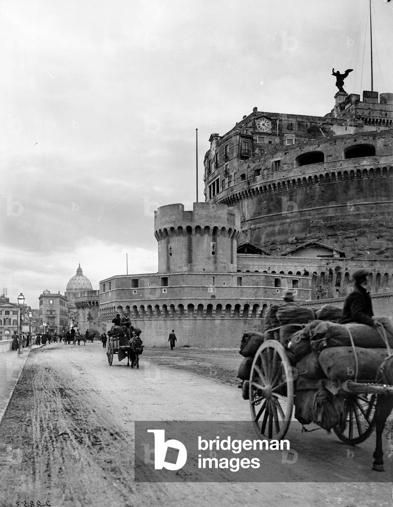 Castle Sant'Angelo in Rome. Some carts passing along lungotevere