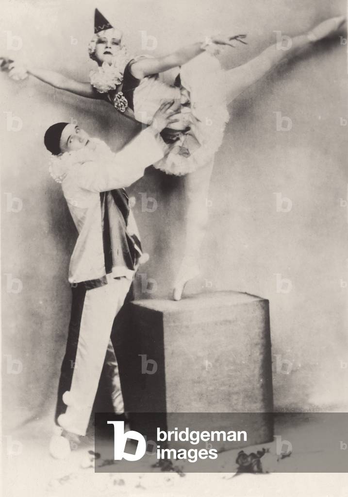 Portrait of a pair of ballet dancers in costumes of Pierrot and Pierrette, seen in a coreographic pose.