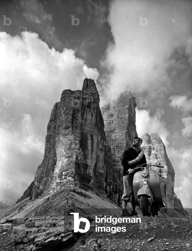 Mountain climber in a scooter in front of the Three Peaks of Lavaredo