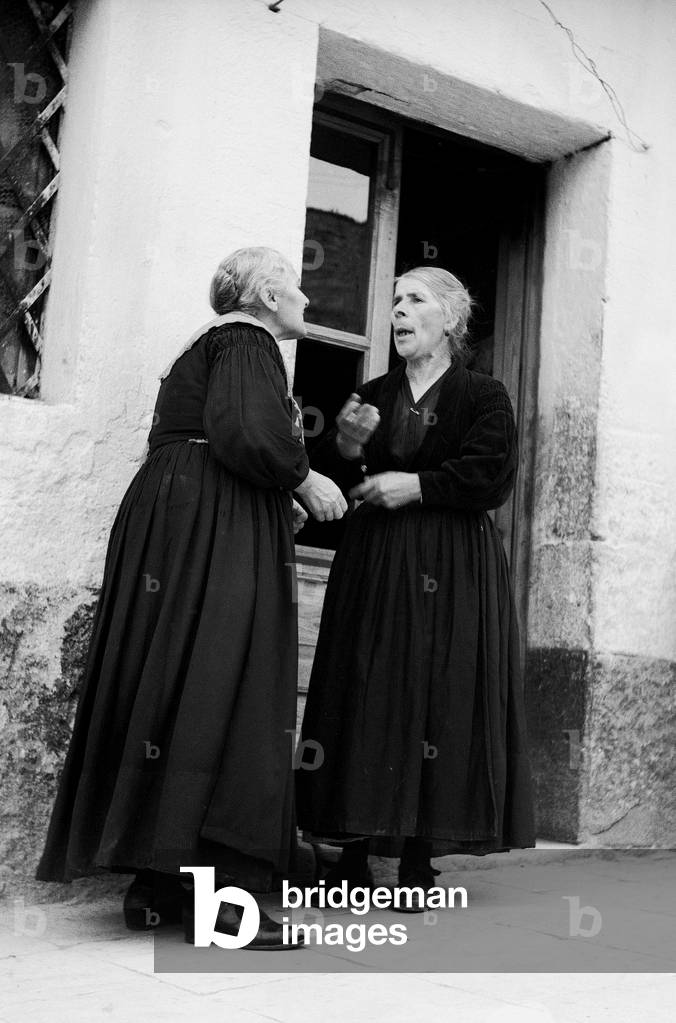 Women conversing in a street of Piana dei Greci (today Piana degli Albanesi), Sicily (b/w photo)