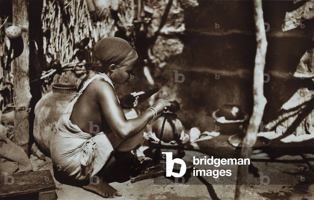 Girl cooking in a hut, 1935 (print on double-weight paper)
