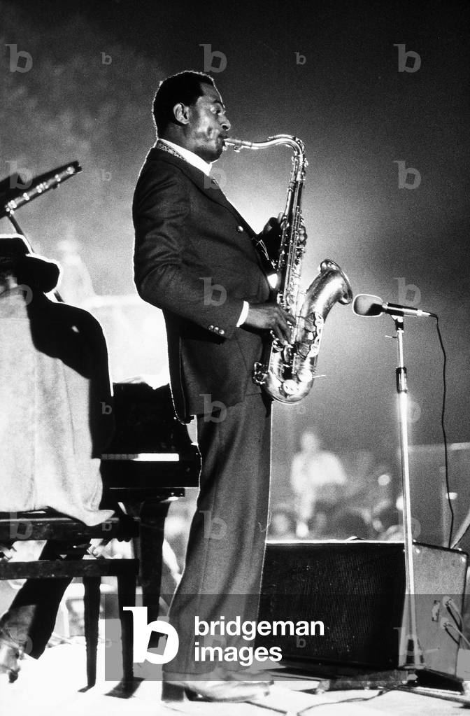 The blues musician Archie Sheep photographed in profile while playing a tenor saxophone.