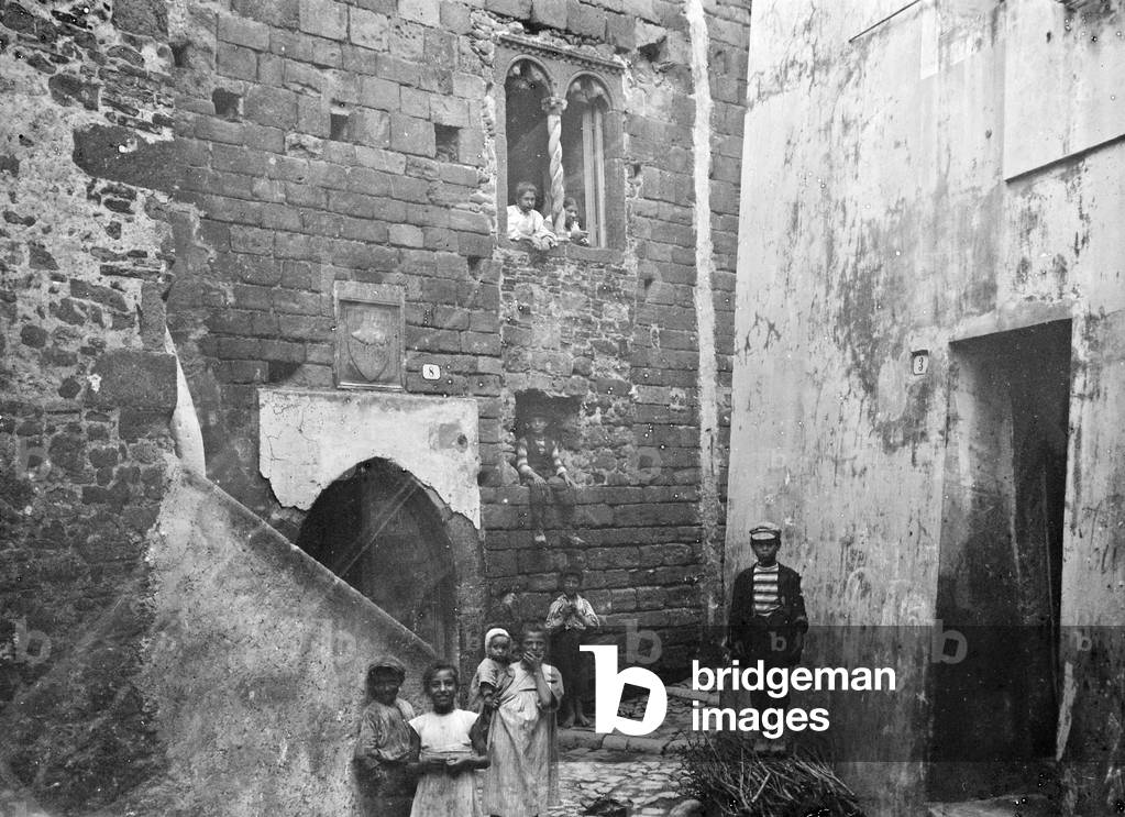 Group of children photographed in an alley in the old town of Nettuno