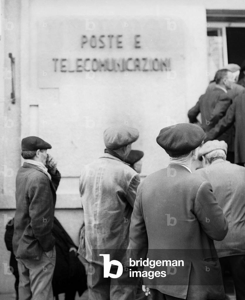 Pensioner standing in front of the post office, 1956